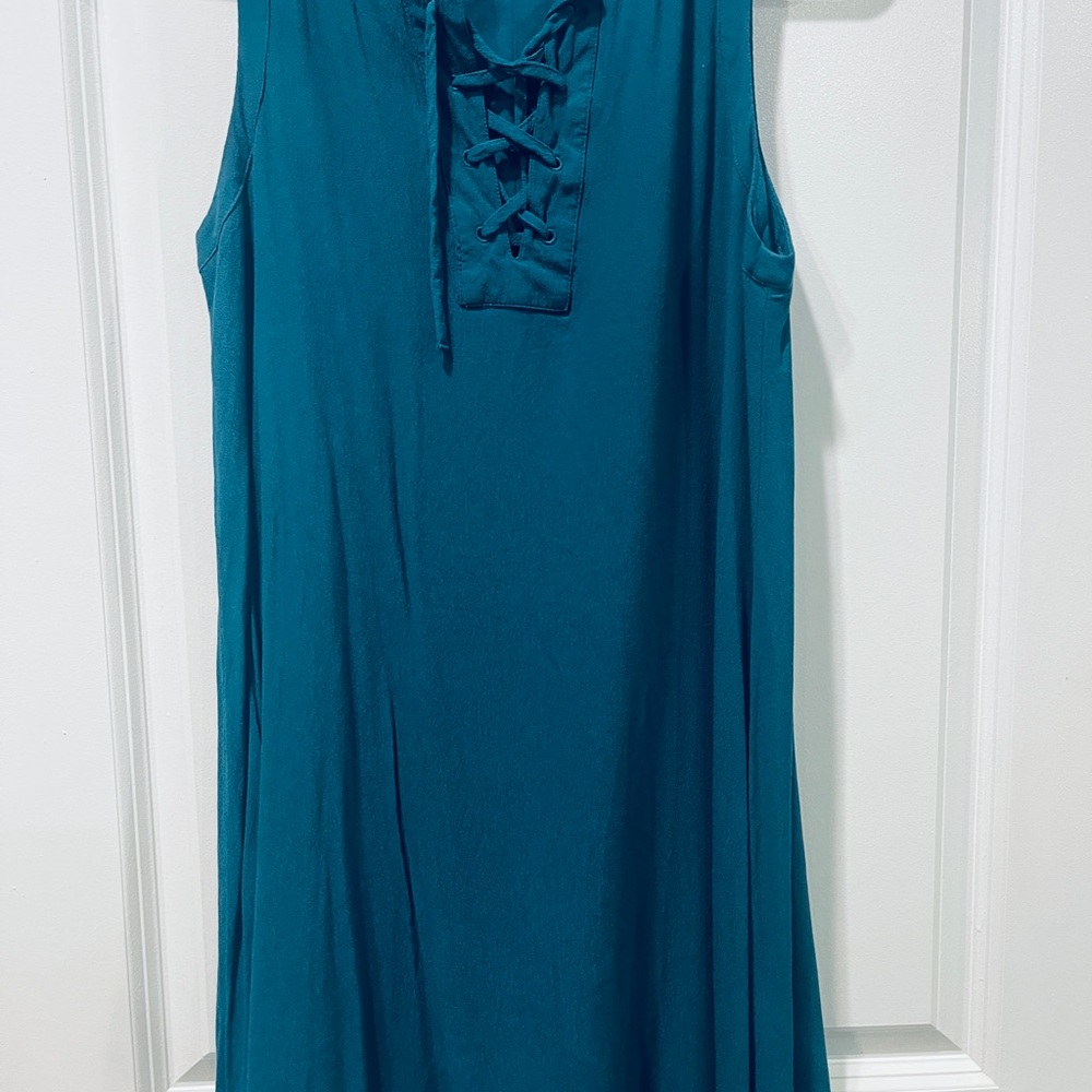 Jade color, tunic length blouse, lace up high chest area